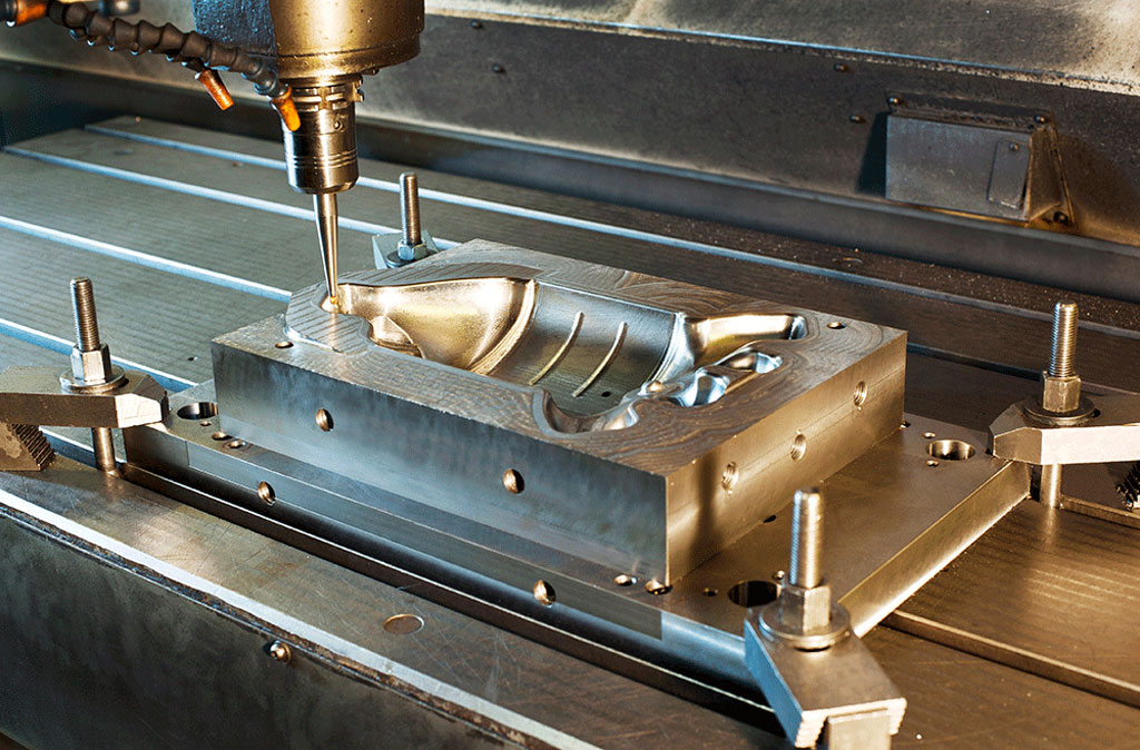 cnc machine carving an injection mold cavity