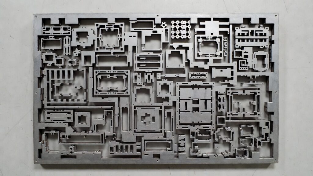 laser-cut complex sheet metal parts nested on a plate